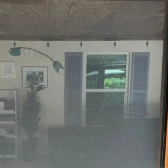 A screen enclosure panel after hand washing, with the view through it clear